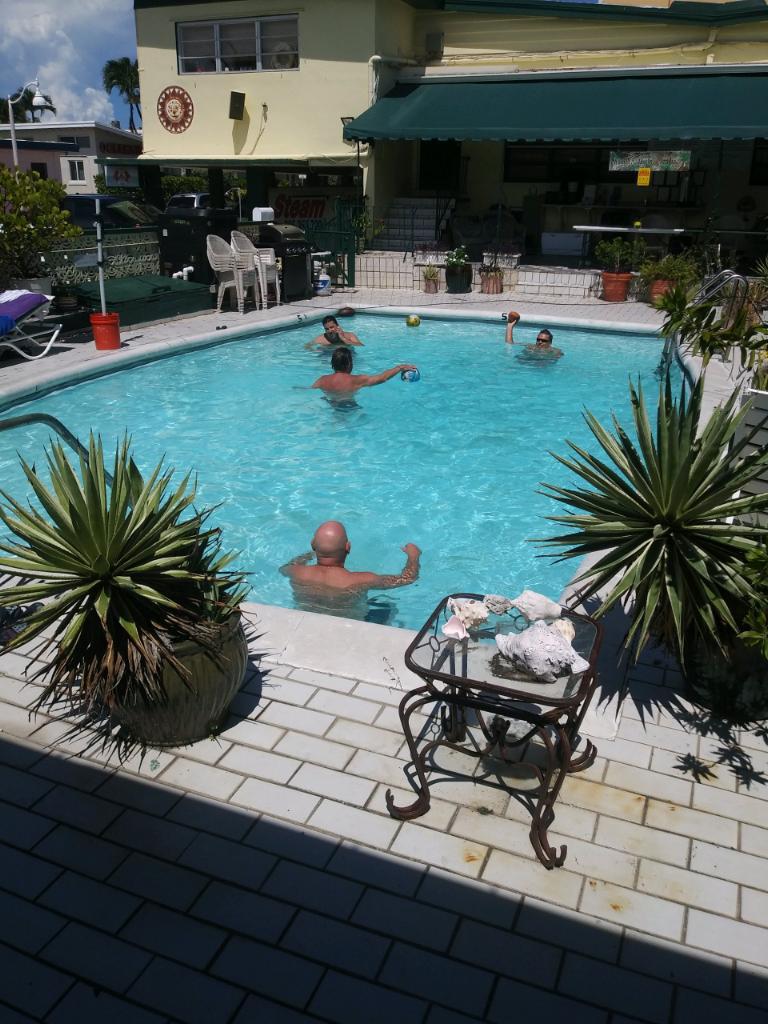 Men Relaxing In Sober Living Swimming Pool