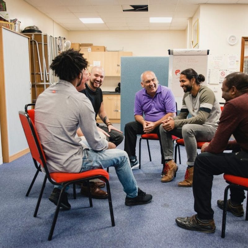 Men Sitting In Recovery Support Group